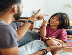 Deaf man and child communicating