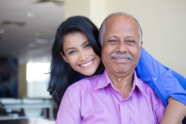 Younger woman hugging an older man